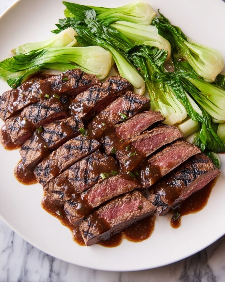 The image shows a white plate with two main layers of food. The bottom layer is made of slices of medium-rare steak, each piece grilled with visible dark grill marks, showing a pink center and a brown outer edge. On top of the steak slices, there is a dark brown sauce drizzled unevenly. Above the steak, towards the back of the plate, there are pale green baby bok choy arranged in small bunches. The whole dish is placed on a white marbled surface. Photo taken with an iphone --ar 4:5 --v 7