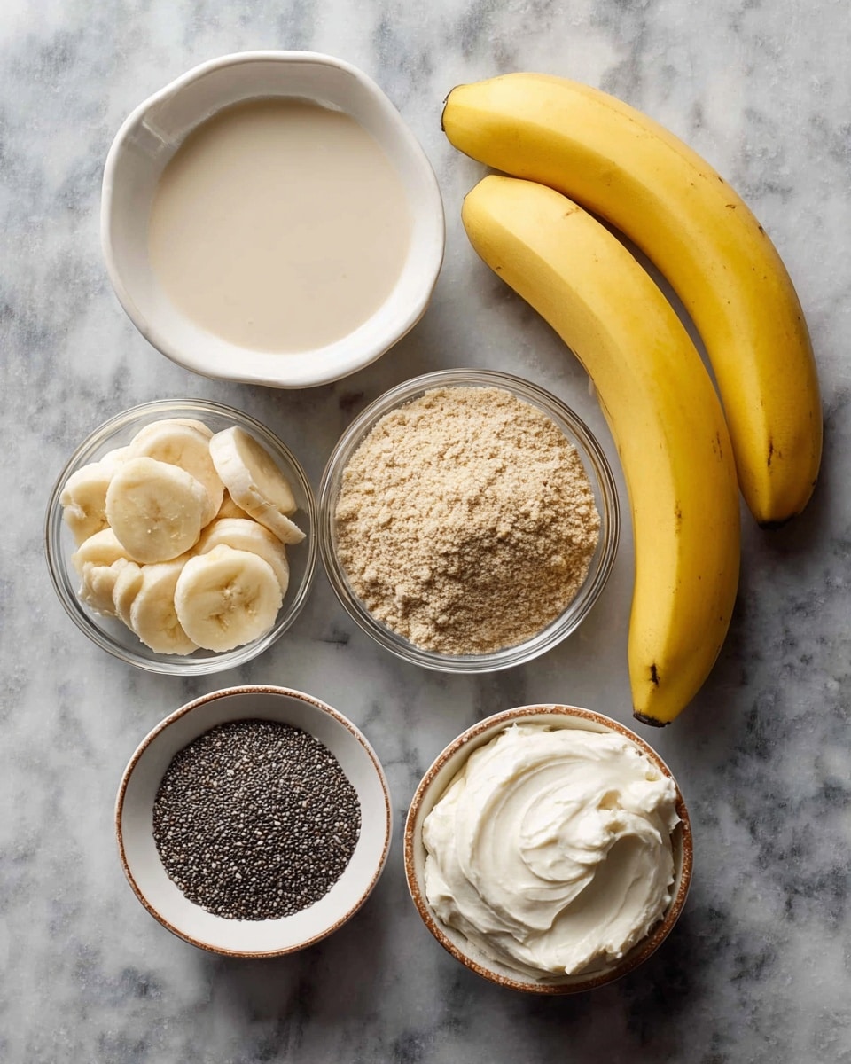 The image shows seven separate ingredients laid out on a dark gray textured surface, changed to a white marbled texture. There are three yellow bananas placed on the right side, smooth and firm. To the left of the bananas are six round slices of banana on a small white plate. Above this plate is a small white bowl filled with a creamy white substance with a thick and slightly rough texture. Next to it, on the left edge, is a larger white bowl filled with a white liquid. Below this, a small glass bowl contains light brown crumbly sugar with a coarse texture. Continuing right, there is a round white plate with a pile of fine white flour. Lastly, nearby, a glass bowl holds small, round black and white chia seeds. Photo taken with an iphone --ar 4:5 --v 7