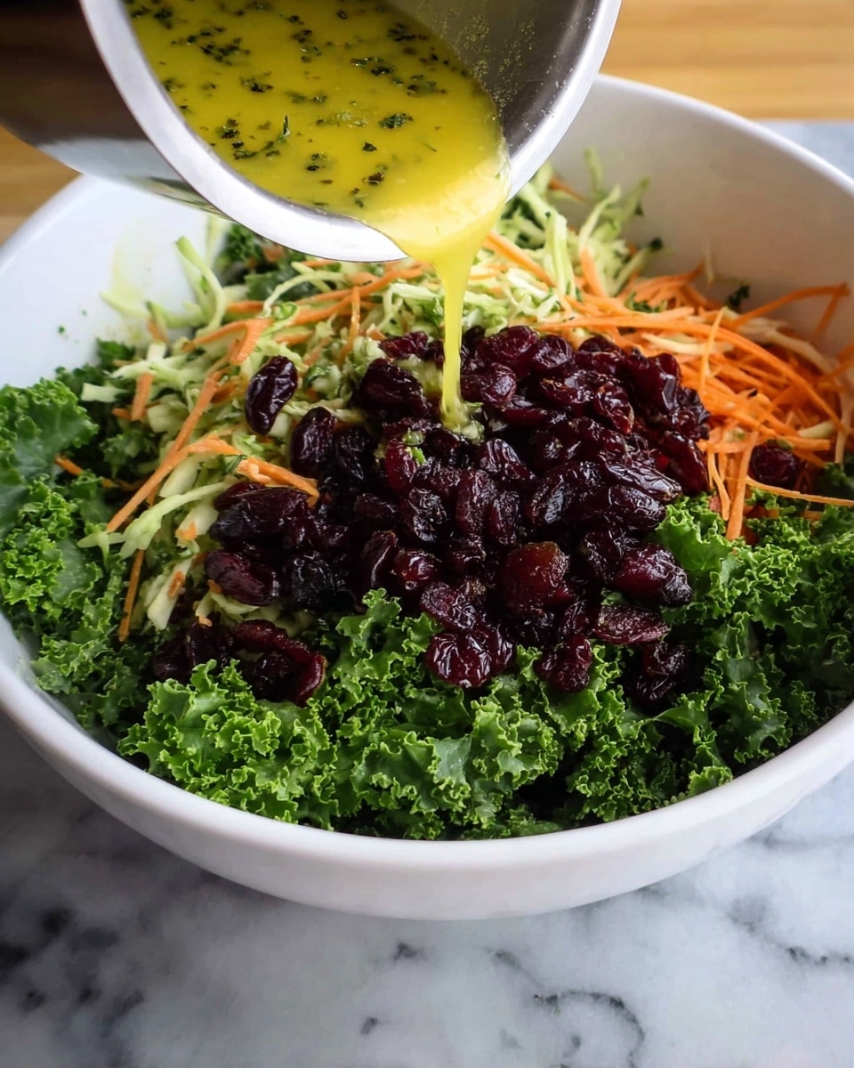 A white bowl filled with three main layers: the bottom layer is bright green curly kale, the middle layer consists of shredded vegetables in light green and orange colors, and the top layer is a heap of dark red dried cranberries. A silver container is pouring a yellow dressing with herbs over the cranberries. The bowl is on a white marbled surface. Photo taken with an iphone --ar 4:5 --v 7
