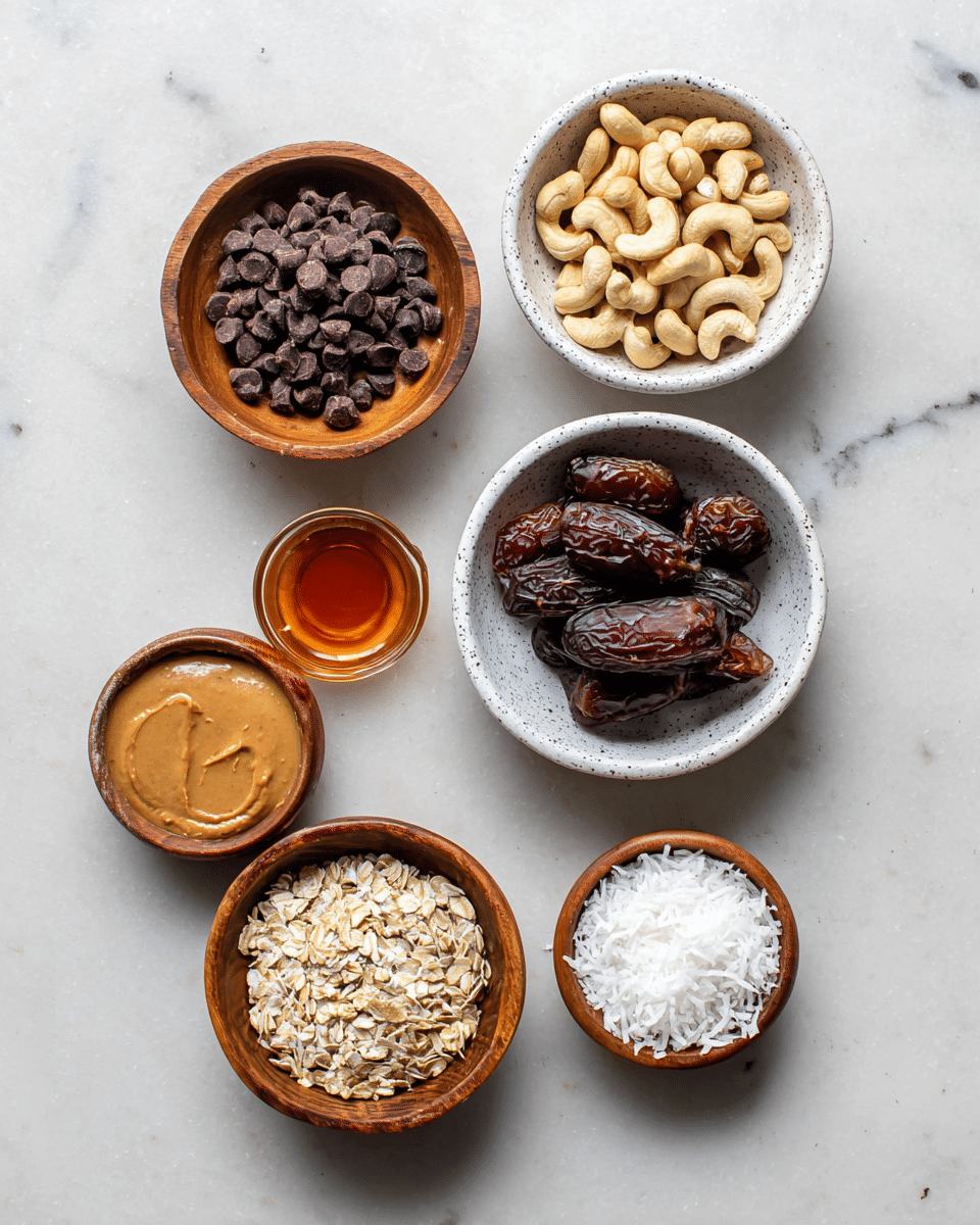 Seven bowls of ingredients are arranged on a white marbled surface. Starting from the top left, a wooden bowl is filled with dark brown chocolate chips, next to a white bowl filled with light tan cashew nuts on the top right. Below the cashews, a white speckled bowl holds dark brown dates. Below the chocolate chips is a small wooden bowl with amber-colored liquid. In the center bottom, a wooden bowl contains light beige oatmeal flakes. To the bottom left, a wooden bowl holds creamy light brown peanut butter. At the very bottom right, a small wooden bowl contains solid white coconut oil, and next to it, a smaller wooden bowl is filled with thin white shredded coconut. photo taken with an iphone --ar 4:5 --v 7