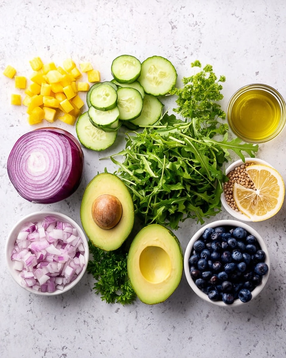 The image shows fresh ingredients neatly arranged on a white marbled surface. From left to right, there are small yellow cubed pieces, whole green cucumber, several cucumber slices with light green color and visible seeds, half a purple onion with layers visible, finely chopped onion pieces below it, a large bunch of leafy green arugula in the center, next is a halved avocado showing its smooth green flesh and brown seed. To the right of the avocado, there is a small white bowl filled with round light brown seeds, another white bowl filled with dark blue blueberries. Beside the bowls are a half lemon with a light yellow interior, fresh green parsley leaves, and a clear jar of yellow oil. The colors are bright and fresh, and the arrangement is clean and balanced. photo taken with an iphone --ar 4:5 --v 7