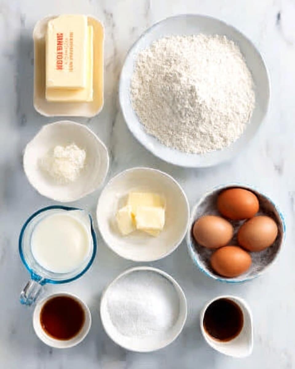The image shows various baking ingredients neatly arranged on a white marbled surface. At the top left, there are two sticks of butter stacked side by side. Next to them is a small white bowl containing a white powdery substance. Below that is a white plate filled with a heap of white flour. In the center, there is a clear glass measuring cup filled with milk. Below the measuring cup is a small white bowl with melted butter. To the right of the flour, there is a white bowl filled with white sugar. At the top right, a small white bowl holds three brown eggs. Below the eggs is a tiny white cup with a dark brown liquid, likely vanilla extract. The ingredients are all set on the white marbled background. photo taken with an iphone --ar 4:5 --v 7