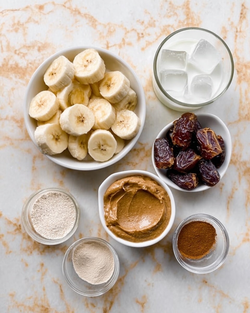 The image shows six small white bowls and glasses arranged neatly on a white marbled surface. The largest bowl on the left is filled with sliced banana pieces, light yellow with brown edges. Next to it on the right is a small white bowl with a smooth almond butter spread, brown and creamy in texture. Below that is another small white bowl holding chopped dark brown dates. Around these main bowls, there is a glass with white milk at the top right corner, a glass filled with clear ice cubes below the milk, a small white bowl with light beige powder, and two small bowls containing a white powder and brown cinnamon powder. The bowls and glasses are placed close together in a tidy layout. Photo taken with an iphone --ar 4:5 --v 7